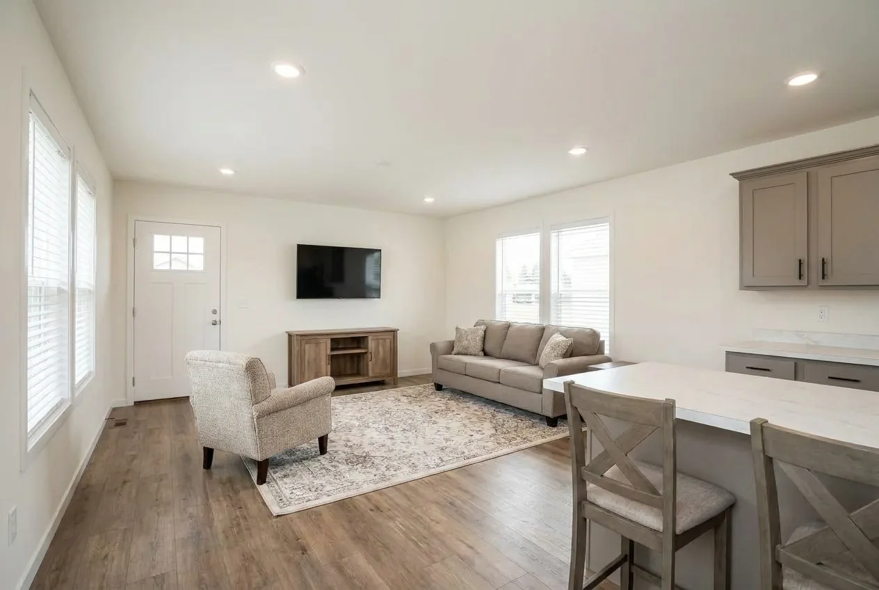 Illustration of the living room in the Sandpointe 14582A (finishes and options may vary)